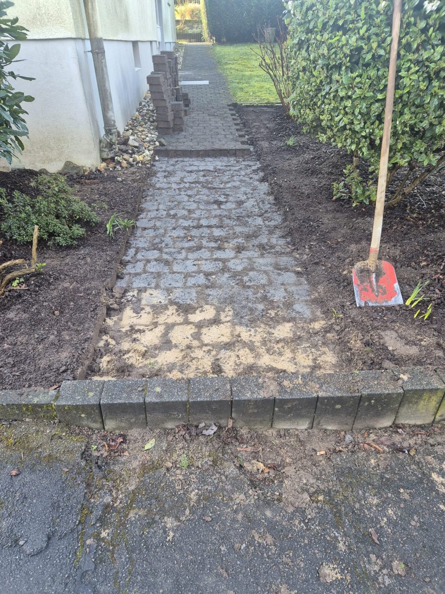 Vorher: Alter, unebener und verwitterter Gartenweg in Hilden vor den Pflasterarbeiten durch Syla Gartenbau